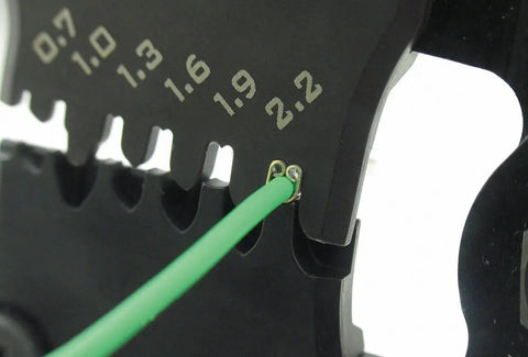 Pro Grade Precision Crimping Tool With Interchangeable Die Set Pad-11 S Size Die Plate, close-up of crimping action on green wire.