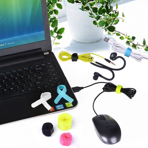 Twenty Pack Reusable Cable Organizer Ties for Earbuds Headphones Chargers and Cables 3 Sizes Assorted Colors in use on laptop desk