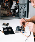 Person using Four Pack 100 MHz 600V DC High Sensitivity Oscilloscope Clip Probe With Switchable Ten To One And One To One on circuit board