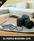 Idea Home microfiber cleaning cloth, gray with black edge, 16x24 in, shown under a camera with a smartphone and glasses.