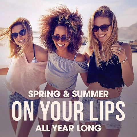 Three smiling women at the beach advertising Sweet Watermelon Lip Balm Trio, Peaches And Cream Lip Balm, Pink Lemonade Lip Balm.