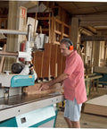 Heavy Duty Hearing Protection Earmuffs Built To Crush Nasty Workshop And Factory Noise Solid Sound Insulation Headband in use at a woodworking shop.