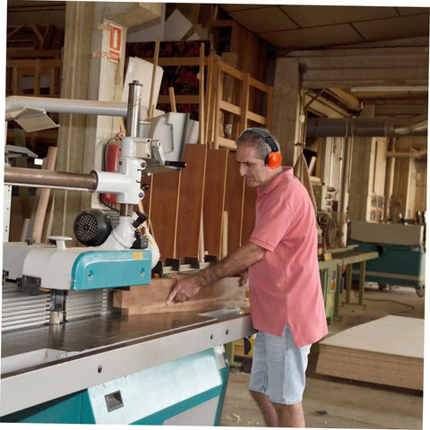 Heavy Duty Hearing Protection Earmuffs Built To Crush Nasty Workshop And Factory Noise Solid Sound Insulation Headband in use at a woodworking shop.