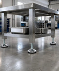 Stainless steel workbench with Beefy Heavy Duty Leveling Feet Set - Adjustable Leveler Legs With 3.15 Inch Base, M16 Thread in use.