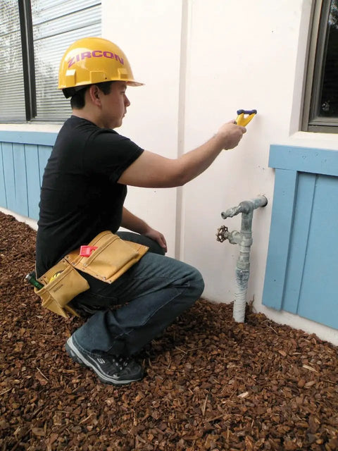 Person using MetalliScanner M40 Handheld Electronic Metal Detector For Drywall Concrete Lathe And Plaster Stucco near outside wall.