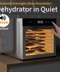 Top Shelf Eight Tray Stainless Steel Food Dehydrator With Kickin 500 Watt Electric Dryer and No Sweat Temp Dialing for Fresh Fruit Lean Beef Jerky Backyard Herbs and Pooch Treats Plus Round Clock Timer showing jerky in stainless trays.