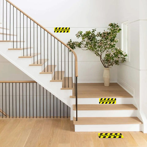 Watch Your Step Sign 5 Pack Budget Friendly Self Adhesive Floor Decals on white stair steps and hallway
