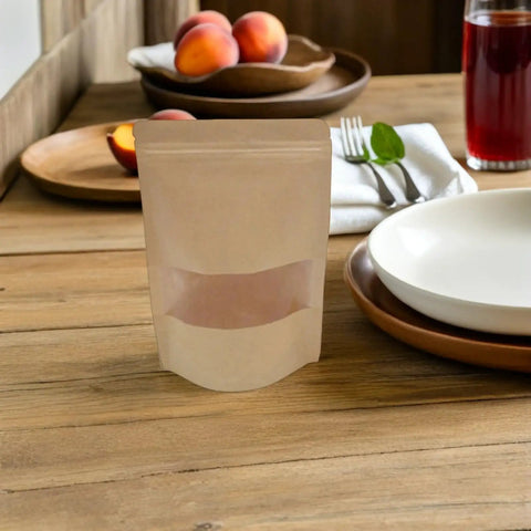 Resealable Kraft Paper Bags With Clear Window For Food Storage And Pantry Organization Pack Of 50 on a wooden table with fruit