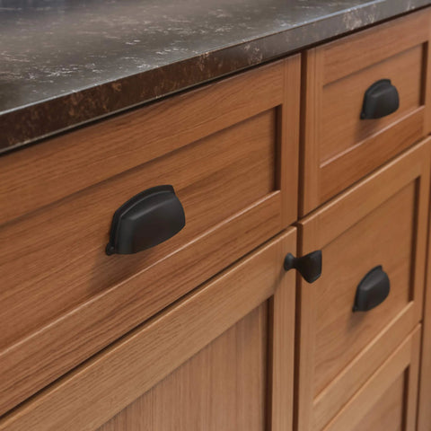 Matte Black Cup Cabinet Pulls 3 Inch Center To Center Handles for kitchen cabinets installed on wooden drawers and doors.