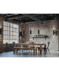 Dining area with modern black 6-Inch Outdoor LED Cylinder Wall Sconce 2-Light Up And Down Mount, rustic brick walls, wooden table.