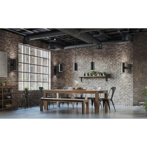 Dining area with modern black 6-Inch Outdoor LED Cylinder Wall Sconce 2-Light Up And Down Mount, rustic brick walls, wooden table.