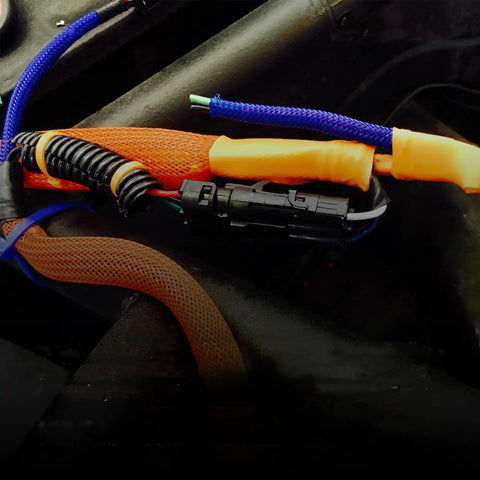 Close-up of 1 Inch PET Expandable Braid Sleeving Flame Retardant Cable Protection Mesh in automotive wiring application
