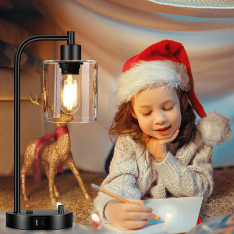 Set Of 2 Industrial Table Lamps With USB C And USB A Ports And Outlet beside child in Santa hat, glass shade illuminated.