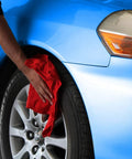 Person using Red Cotton Shop Towels 145 Pack Commercial Grade 14 By 12 Inches Reusable Cleaning Rags on car tire