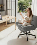 Grey Cross Legged Desk Chair With Foot Rest, Cozy Teddy Plush Upholstery, featured in a home office setting with pet.