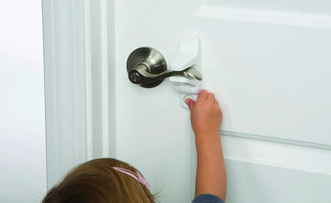 Child reaching for OutSmart Lever Handle Lock 4 Pack White Kid Safe Kidproof Lock on door handle, showing easy installation and safety feature.