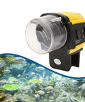 Dead Simple Automatic Fish Feeder With Battery Powered Digital Timer And Sleek LCD Panel, yellow plastic design, aquarium use.