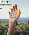 Close-up of a Portable Orienteering Compass With Luminous Pointer And Ruler held in hand outdoors, showcasing its lightweight design.