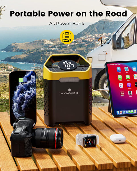 Cordless 160 PSI Tire Inflator Portable Air Pump With Digital Gauge And LED Light shown charging electronic devices on a picnic table.