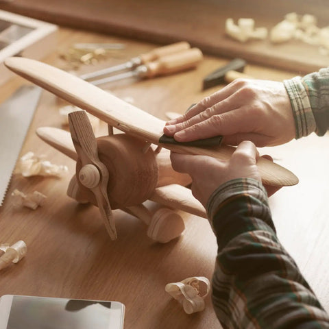 Hands polishing wood model plane with Top Notch Wet Dry Sandpaper Set 9 By 11 Inches With Grits 1500 2000 2500 3000 5000 7000