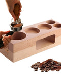 Solid Wood Espresso Tamper Holder 58Mm With Integrated Drip Tray Natural Coffee Tamping Station in use with coffee grounds.