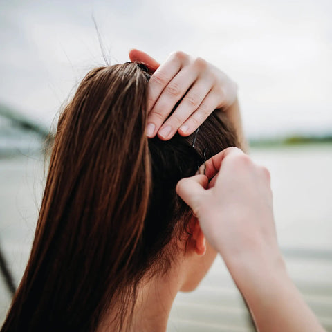 Professional Ball Tipped Bobby Pins Lock It Down With An Insanely Secure Crimped Grip Perfect For Updos And Taming Flyaways 400 Count Black Hair Clips For Everyday Styling in use on ponytail.