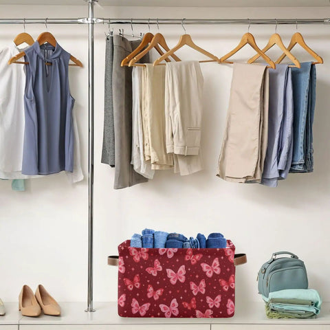 Collapsible Canvas Storage Basket With Waterproof Interior And Sturdy Handles For Bedroom Closet Organization, holding rolled denim in a red butterfly design.