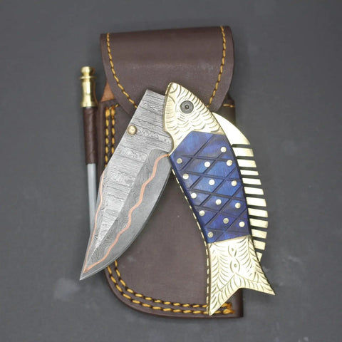 Custom Copper Damascus Fish Style Folding Knife with ladder pattern blade, brass engraved handle, and leather sheath.