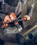 Worker using 18V Brushless Cordless Drill Driver Set Packs Badass Torque And Four Speeds Hammer Mode on metal.