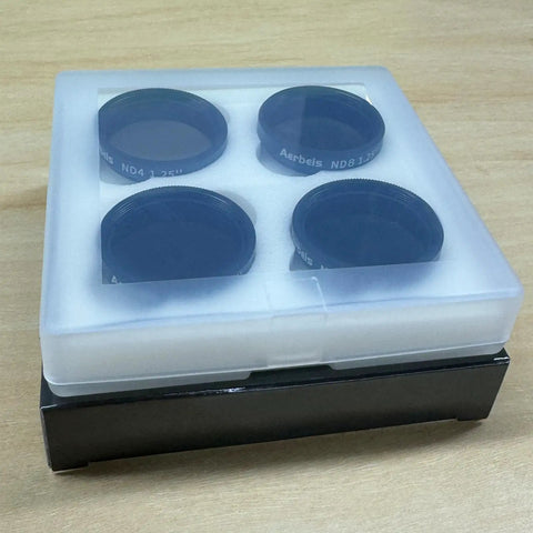 1.25 Inch Moon Filter Kit For Telescope With ND4 ND8 ND16 ND32 in plastic case on wooden surface