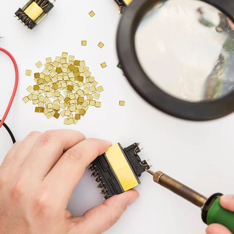 150 Pieces Gold Plated Copper Solder Chips For Jewelry Making And Electronics Repair with hands using soldering iron