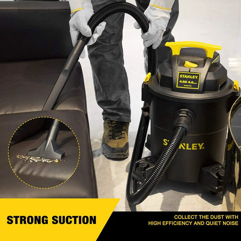 Person using Beast Mode Wet Dry Vacuum With 6 Gallon Tank And 4 HP Power For Quick Cleanups on sofa, showing suction and attachments.