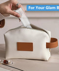 Person placing Four Pack 3.4 Oz Travel Bottles Set for Toiletries, TSA Approved, Leak Proof Plastic Containers into a bag.