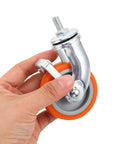 4pcs Inch M8 TPR Rolling Furniture Casters with Brake Orange held by hand, showcasing smooth swivel action and durable rubber wheel.