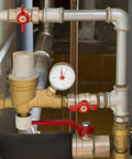 Industrial piping system with pressure gauge and valves, featuring heavy-duty SCH40 components for plumbing and gas lines.