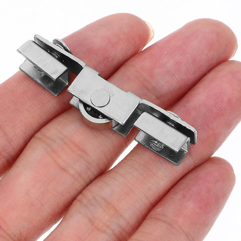 Eight Piece Glass Sliding Door Pulley Roller Kit With Heavy Duty Track Guide For Closets And Windows showing a silver steel roller in hand