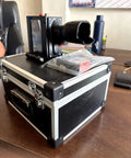 Hella Portable Handheld Inkjet Printer With Rechargeable Battery Tough Carry Case on a wooden desk ready for use.
