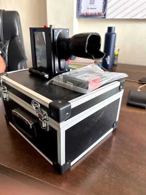 Hella Portable Handheld Inkjet Printer With Rechargeable Battery Tough Carry Case on a wooden desk ready for use.