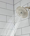 Elmhurst Shower Trim Kit With Tub Spout In Brushed Nickel Finish spraying water in shower with white tile