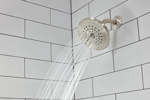 Elmhurst Shower Trim Kit With Tub Spout In Brushed Nickel Finish spraying water in shower with white tile