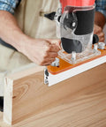 Top Tier Aluminum Wood Trimmer Router Base With Adjustable Slotting Bracket Drops Right In For Butter Smooth Routing And Reliable Cuts On Lumber Fits 65 Mm Bore Accepts 6 To 56 Mm Shafts, in use with wooden board.