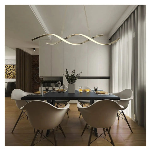 Modern Wave LED Pendant Light Featuring Brushed Gold Finish And Clean Geometric Lines above a dining table in a contemporary setting.