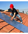 Man applying Heavy Duty Self Adhesive Asphalt Roof Patch Tape Featuring Sbs Bitumen Waterproof Roll on a tile roof.