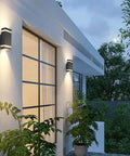 Porch Light With Dusk To Dawn Sensor For Outdoors, Square Up And Down Exterior Wall Sconce, illuminating a modern porch