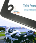 Close-up of Badass Matte Black Stainless Steel Motorcycle License Plate Frame with thick 1.3mm durable edge in scenery.