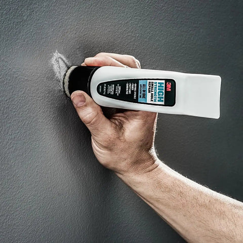 No Sweat Wall Patch Tube, High Strength Spackle With Built-In Applicator Wand, being applied to wall nail hole.