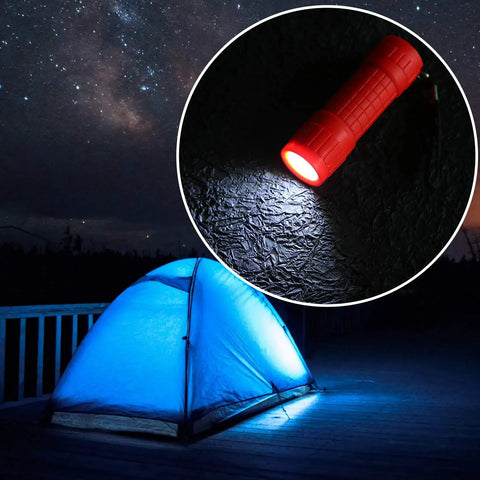 Red mini flashlight from 30 Pack Mini LED Flashlights Set with 9 LED Beams, 90 AAA Batteries Included, illuminating beside a blue tent.