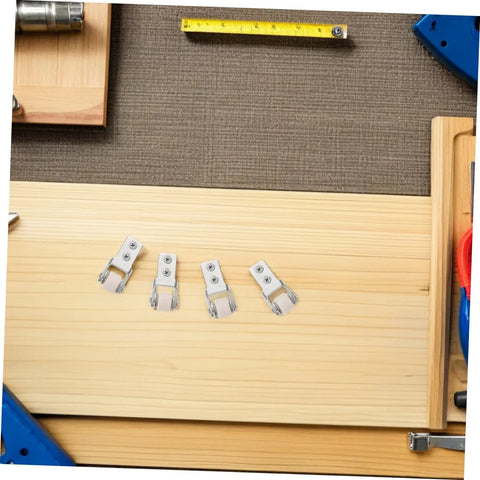 Six Pack Nylon Guide Wheels In Clean White For Furniture Track Systems And Drawer Hardware on wooden surface with measuring tape.