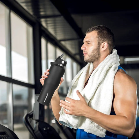 Man in gym holding Smooth Operator 40oz Stainless Steel Vacuum Insulated Water Bottle With Straw And Spout Lids Kept Ice Cold For Two Full Days Fits Every Car Cup Holder For Weekend Drifts Summer Vibes And Travel Black.