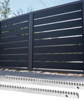 Beefy Heavy Duty Steel Gear Rack Kit, 2 pieces shown beneath sliding gate, Q235 steel construction, straight gears visible